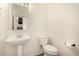 Powder room features pedestal sink, toilet, and modern fixtures at 379 E Cheyenne Rd, San Tan Valley, AZ 85143