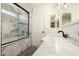 Modern bathroom featuring marble shower, white vanity with marble countertop, and updated fixtures at 379 E Cheyenne Rd, San Tan Valley, AZ 85143