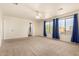 Spacious bedroom with neutral carpet, ceiling fan, and large windows with blue curtains at 379 E Cheyenne Rd, San Tan Valley, AZ 85143