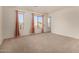 A spacious bedroom with three windows letting in plenty of natural light and views of the outside at 379 E Cheyenne Rd, San Tan Valley, AZ 85143