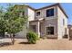 An angled view of the home reveals a beige stucco facade and tidy xeriscaped yard at 379 E Cheyenne Rd, San Tan Valley, AZ 85143