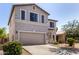 This beige stucco home showcases a two-car garage, xeriscaping, and neutral trim at 379 E Cheyenne Rd, San Tan Valley, AZ 85143