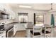 Bright kitchen features white cabinetry, stainless steel appliances, and a large island with bar seating at 379 E Cheyenne Rd, San Tan Valley, AZ 85143