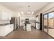 Spacious kitchen featuring white cabinets, stainless steel appliances, and sliding doors to the backyard at 379 E Cheyenne Rd, San Tan Valley, AZ 85143