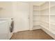 Bright laundry area showcasing tile flooring, storage shelves, and modern washer and dryer appliances at 379 E Cheyenne Rd, San Tan Valley, AZ 85143