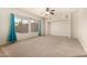 Bright, spacious living room with neutral carpeting and large windows overlooking the backyard at 379 E Cheyenne Rd, San Tan Valley, AZ 85143