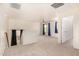 Open floor plan living room with gray carpet, natural light, and doors leading to other rooms at 379 E Cheyenne Rd, San Tan Valley, AZ 85143