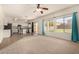 Open-concept living room with neutral carpet, a ceiling fan, and kitchen access at 379 E Cheyenne Rd, San Tan Valley, AZ 85143