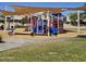 Bright outdoor playground area offering a variety of play structures and sun shades at 379 E Cheyenne Rd, San Tan Valley, AZ 85143