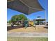Community playground with shade structure featuring slides and a seesaw for neighborhood Gathering fun at 379 E Cheyenne Rd, San Tan Valley, AZ 85143