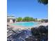 Community pool with lounge chairs, a gazebo, greenery, and a lifeguard station on a sunny day at 379 E Cheyenne Rd, San Tan Valley, AZ 85143