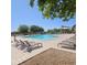 Community pool with lounge chairs, a gazebo and lush landscaping on a sunny day at 379 E Cheyenne Rd, San Tan Valley, AZ 85143