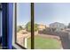 View from bedroom window showcasing a well-maintained backyard and neighborhood houses at 379 E Cheyenne Rd, San Tan Valley, AZ 85143