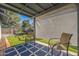 Cozy covered patio space with comfortable seating and an artificial turf view at 3833 W Phelps Rd, Phoenix, AZ 85053