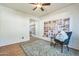 Bedroom featuring wood floors, ceiling fan, and an accent wall with bookshelves at 3833 W Phelps Rd, Phoenix, AZ 85053