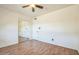 Bedroom with wood floors, a ceiling fan, and mirrored closet doors at 3833 W Phelps Rd, Phoenix, AZ 85053