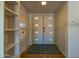 Bright entryway featuring tiled floors, coat closet and shelving at 3833 W Phelps Rd, Phoenix, AZ 85053