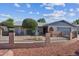 Charming single-story home featuring a quaint courtyard with a fountain and manicured landscaping at 3833 W Phelps Rd, Phoenix, AZ 85053