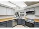 Bright kitchen features stylish cabinets, stainless steel appliances, and a window overlooking the backyard pool at 3833 W Phelps Rd, Phoenix, AZ 85053