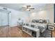 Bright main bedroom featuring a ceiling fan, warm wood floors, and stylish furnishings at 3833 W Phelps Rd, Phoenix, AZ 85053
