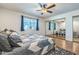 Bright main bedroom with mirrored closet doors and a large window looking out onto the patio at 3833 W Phelps Rd, Phoenix, AZ 85053