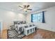 Comfortable main bedroom with a large window offering natural light and warm wood flooring at 3833 W Phelps Rd, Phoenix, AZ 85053