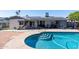 Backyard pool featuring a tanning ledge and solar panels on the house for energy efficiency at 3833 W Phelps Rd, Phoenix, AZ 85053