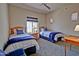 This bedroom includes two twin beds with wood frames and a window at 3935 E Rough Rider Rd # 1360, Phoenix, AZ 85050