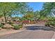 Gated entrance to residential community with mature trees and landscaping at 3935 E Rough Rider Rd # 1360, Phoenix, AZ 85050