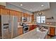 Modern kitchen featuring stainless steel appliances, wood cabinets, and a beautiful island with stone countertops at 3935 E Rough Rider Rd # 1360, Phoenix, AZ 85050