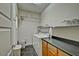 Well-lit laundry room with storage cabinets, utility sink, and shelving at 3935 E Rough Rider Rd # 1360, Phoenix, AZ 85050