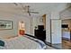 This primary bedroom features wood flooring, a ceiling fan, and a doorway to a bathroom, enhancing its appeal at 3935 E Rough Rider Rd # 1360, Phoenix, AZ 85050