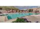 Large community swimming pool with covered seating and ample deck space and flowers at 3935 E Rough Rider Rd # 1360, Phoenix, AZ 85050