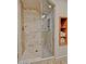 This walk-in shower features neutral-toned tiles and a glass door at 3935 E Rough Rider Rd # 1360, Phoenix, AZ 85050
