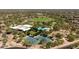 An aerial view of the community featuring lush green spaces, pool, tennis courts, and a playground at 3964 E Hummingbird Ln, Phoenix, AZ 85050