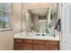 Bathroom with white countertop vanity with single sink and large mirror at 3964 E Hummingbird Ln, Phoenix, AZ 85050