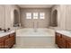 Relaxing primary bathroom featuring soaking tub, neutral paint and abundant natural light at 3964 E Hummingbird Ln, Phoenix, AZ 85050