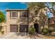 Charming two-story home featuring a tile roof, dark brown shutters, and arched front door at 3964 E Hummingbird Ln, Phoenix, AZ 85050