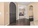 Inviting foyer with dark wood floors, an arched front door, and views into a bright, open living space at 3964 E Hummingbird Ln, Phoenix, AZ 85050