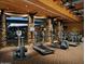 Gym with wood paneled ceiling, stone pillars and multiple workout machines at 3964 E Hummingbird Ln, Phoenix, AZ 85050