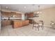 Spacious kitchen featuring wooden cabinetry, a kitchen island, tile floors, and a dining area for gatherings at 3964 E Hummingbird Ln, Phoenix, AZ 85050