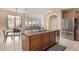 Modern kitchen island with a stainless steel dishwasher, stone countertop, and a connected dining area for convenient living at 3964 E Hummingbird Ln, Phoenix, AZ 85050