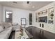 Comfortable living room with a sectional sofa, built-in shelves, and hardwood floors, creating a cozy and functional space at 3964 E Hummingbird Ln, Phoenix, AZ 85050