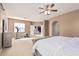 Spacious main bedroom boasts a ceiling fan, large windows, and an open floor plan at 3964 E Hummingbird Ln, Phoenix, AZ 85050