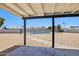Covered patio overlooking a large backyard with a gated pool, perfect for outdoor enjoyment at 4117 W Camino Acequia Ave, Phoenix, AZ 85051