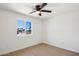Bright bedroom with light wood floors, a ceiling fan, and a window offering a neighborhood view at 4117 W Camino Acequia Ave, Phoenix, AZ 85051