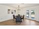 Bright dining room with wood floors, modern light fixture, and access to the backyard at 4117 W Camino Acequia Ave, Phoenix, AZ 85051