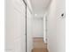Bright hallway featuring wood-look floors, double closet, white walls, and recessed lighting at 4117 W Camino Acequia Ave, Phoenix, AZ 85051