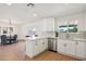 Bright, updated kitchen featuring white cabinets, stainless appliances, and adjacent dining area at 4117 W Camino Acequia Ave, Phoenix, AZ 85051