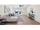 Bright living room with hardwood floors, neutral decor, a ceiling fan, and an entry door view at 4117 W Camino Acequia Ave, Phoenix, AZ 85051